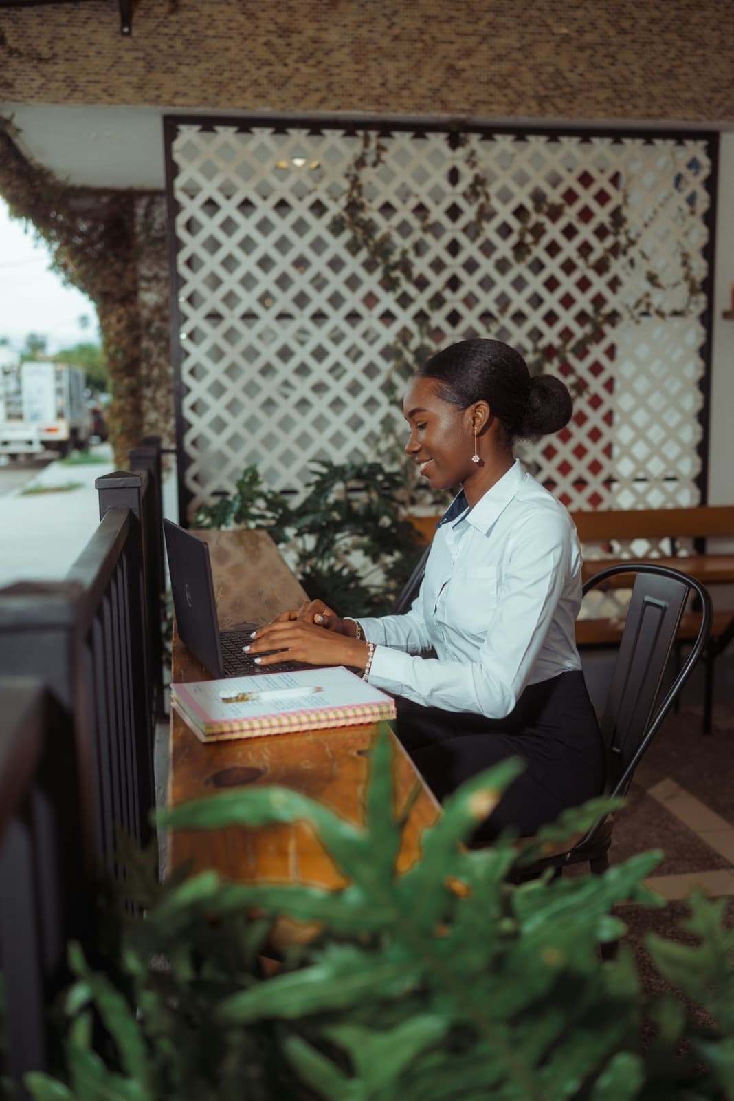 A specialist working on her laptop on a porch