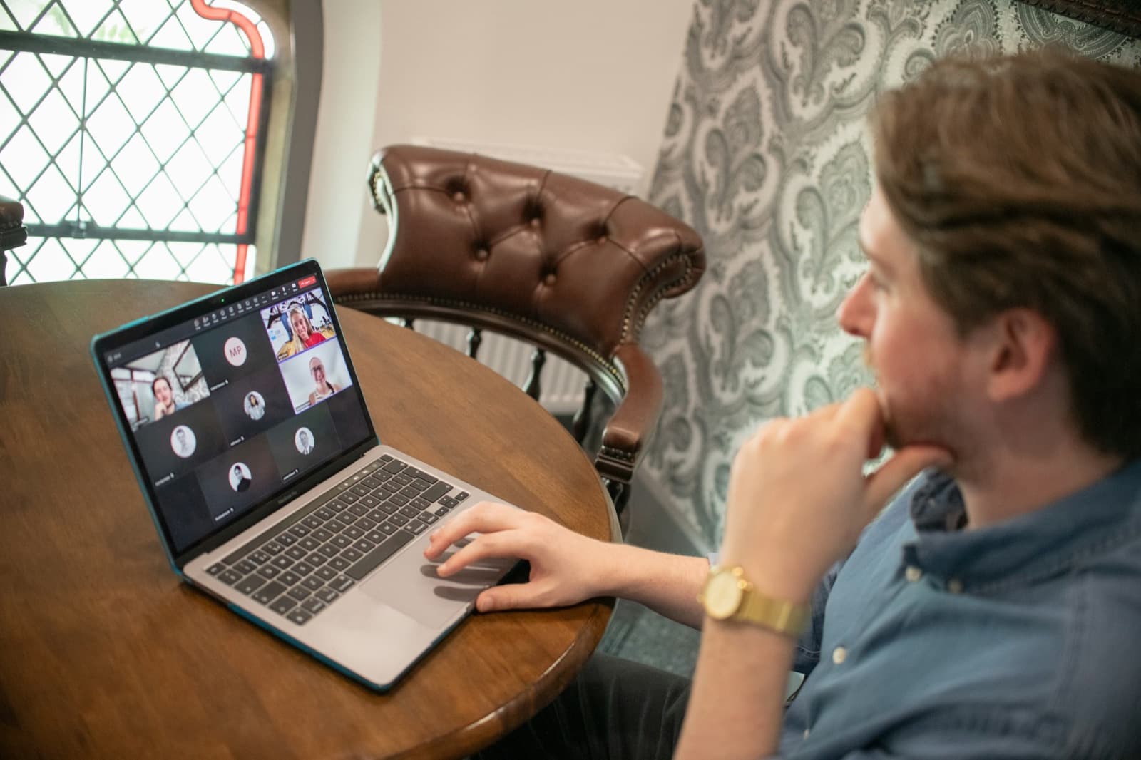 A remote team meeting on a laptop at home