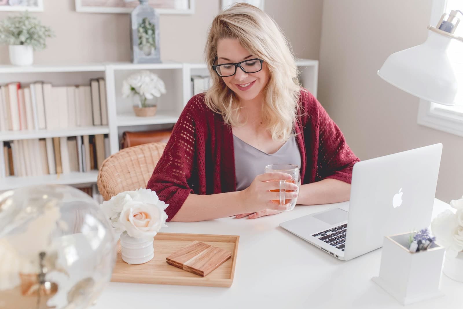 A smiling specialist at her laptop
