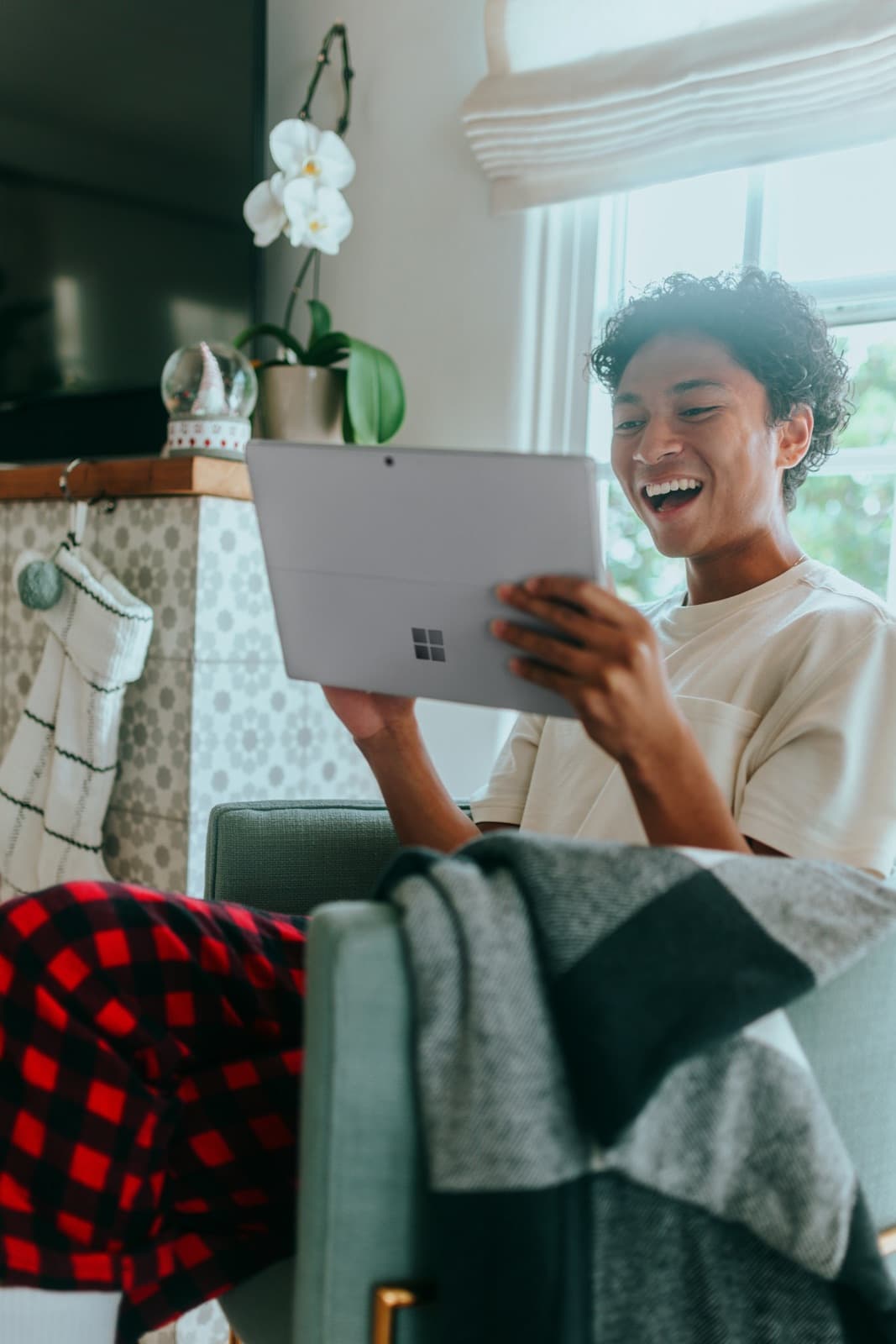 A specialist laughing during a call at home